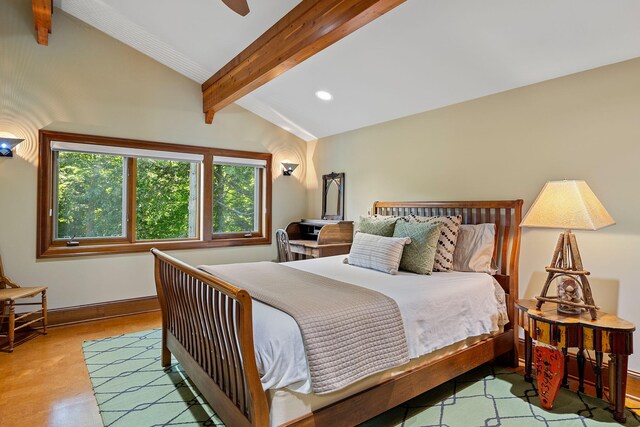 bedroom featuring vaulted ceiling with beams, light hardwood / wood-style floors, and ceiling fan