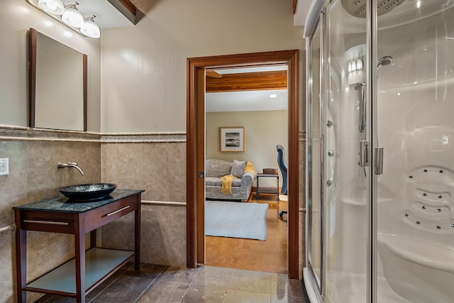 bathroom with vanity, tile walls, tile patterned flooring, and an enclosed shower