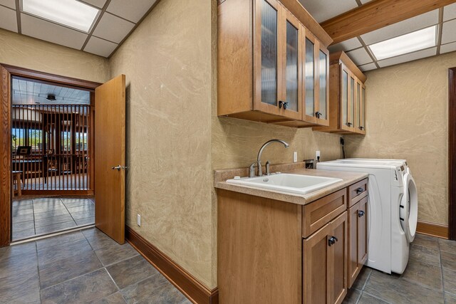 kitchen featuring washer and clothes dryer, a paneled ceiling, and sink