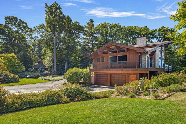 view of property exterior with a lawn and a garage