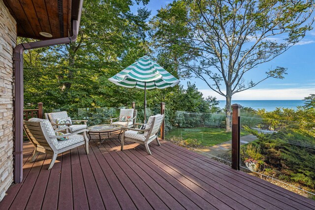 deck featuring a water view and an outdoor living space