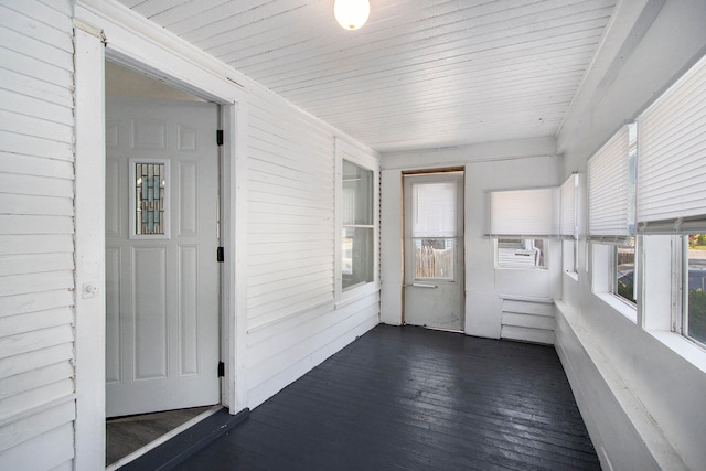 unfurnished sunroom with wood ceiling