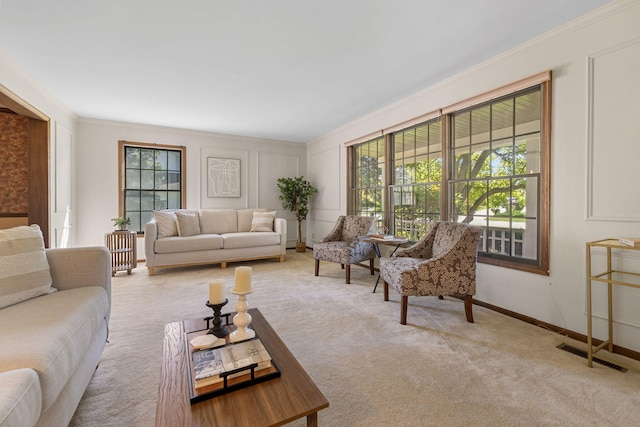 living room featuring light carpet, plenty of natural light, and ornamental molding