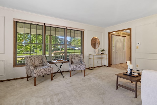 living area with light colored carpet and ornamental molding