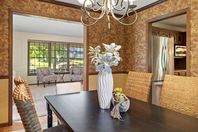 dining space with crown molding and an inviting chandelier