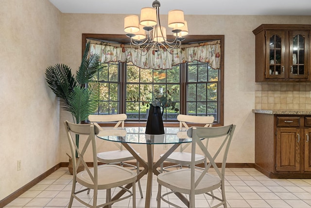 tiled dining space featuring a chandelier