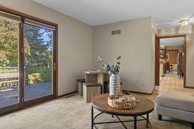 living area featuring light colored carpet