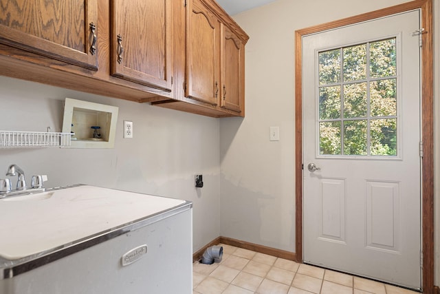 laundry area featuring washer hookup, cabinets, light tile patterned floors, and hookup for an electric dryer