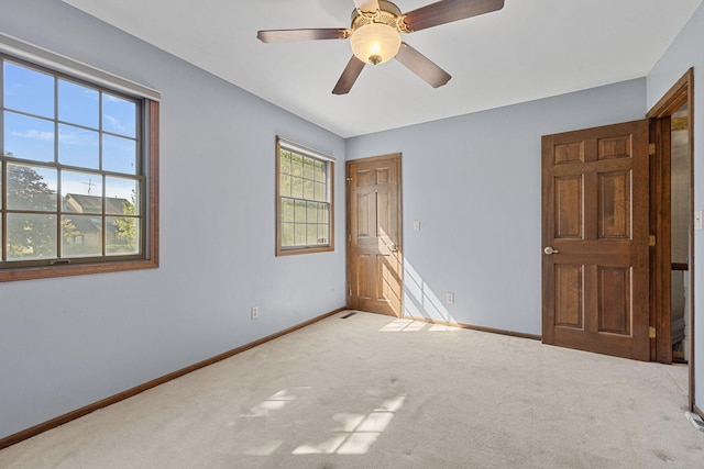 unfurnished bedroom featuring ceiling fan and carpet