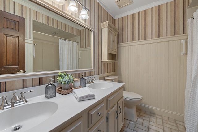 bathroom with curtained shower, crown molding, vanity, and toilet