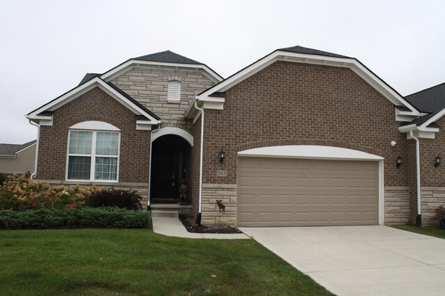 view of front facade with a garage and a front lawn