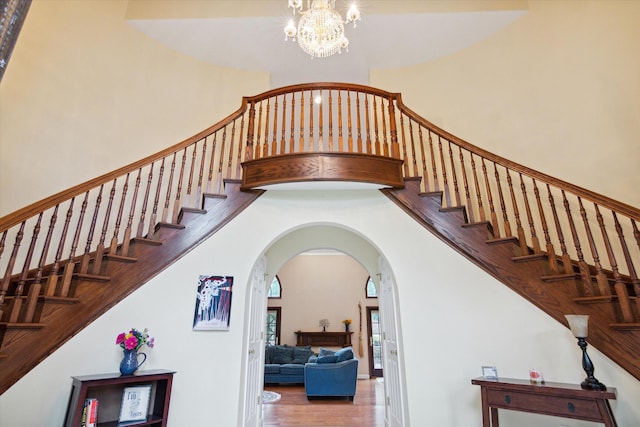 stairway featuring a chandelier and hardwood / wood-style flooring