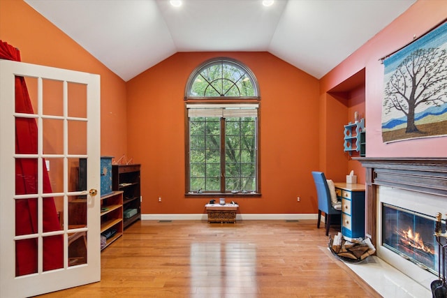 home office with wood-type flooring and lofted ceiling