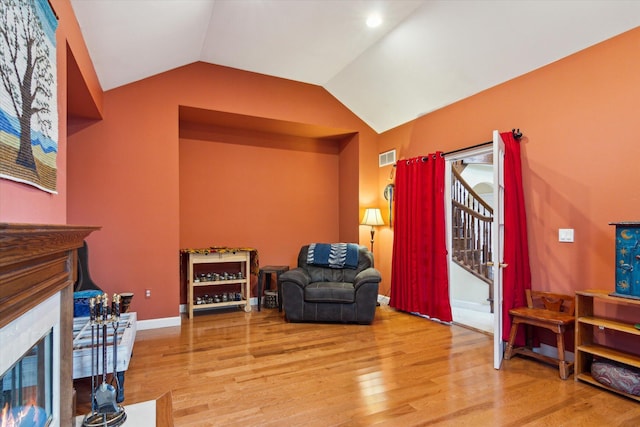 sitting room with vaulted ceiling and hardwood / wood-style flooring