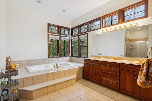 bathroom featuring vanity, tile patterned flooring, a wealth of natural light, and plus walk in shower