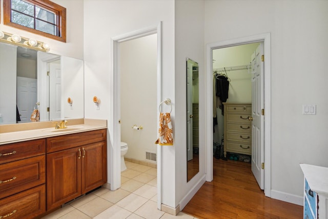 bathroom featuring tile patterned floors, toilet, and vanity