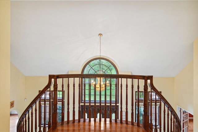 stairs featuring a chandelier