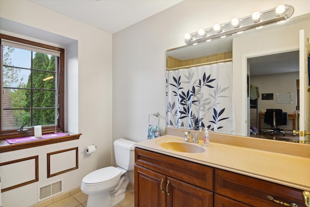 bathroom with toilet, tile patterned floors, and vanity