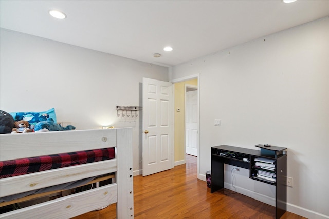 bedroom with hardwood / wood-style floors