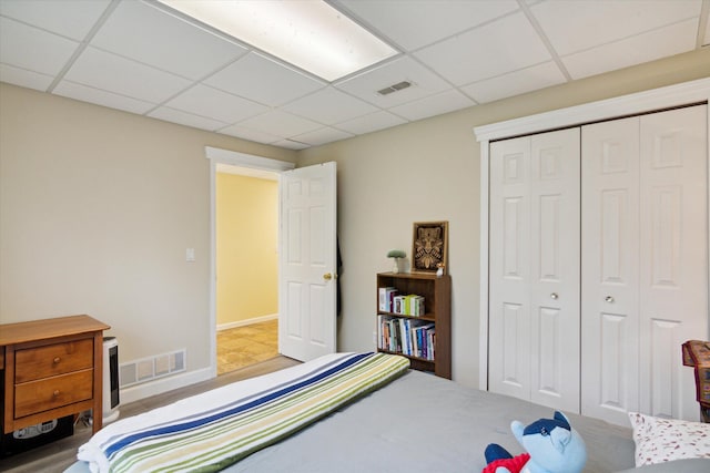 bedroom with a closet and a drop ceiling