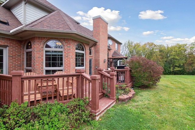 wooden terrace featuring a yard