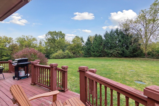 deck featuring a lawn and grilling area