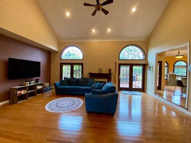 living room with hardwood / wood-style floors, french doors, and high vaulted ceiling