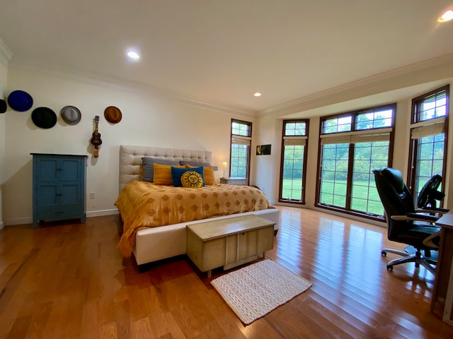 bedroom featuring light wood-type flooring and crown molding