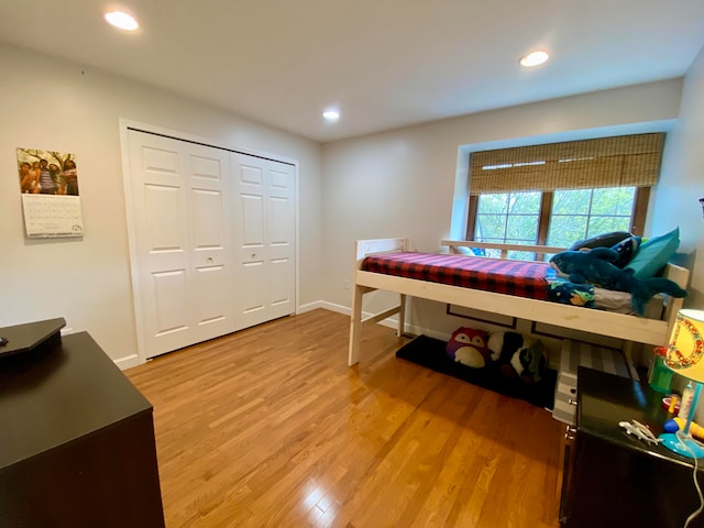 bedroom featuring a closet and light wood-type flooring