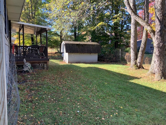 view of yard featuring a wooden deck and a shed