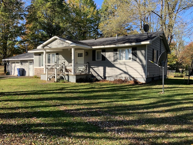 view of front facade with a front yard, a porch, and a garage