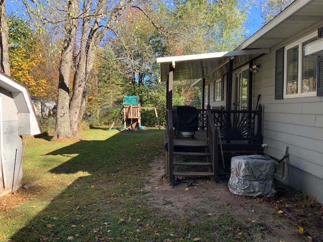 view of yard featuring a wooden deck and a playground