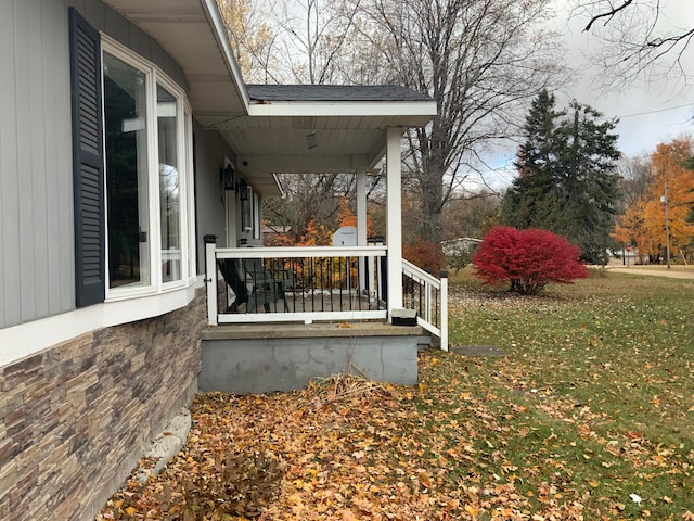 exterior space with covered porch and a lawn