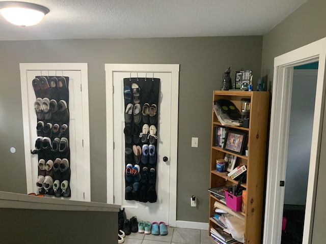 spacious closet with light tile patterned floors