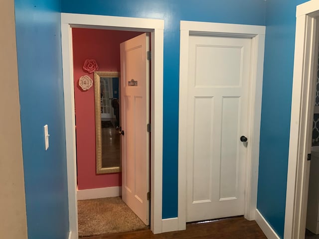 hallway with dark hardwood / wood-style floors