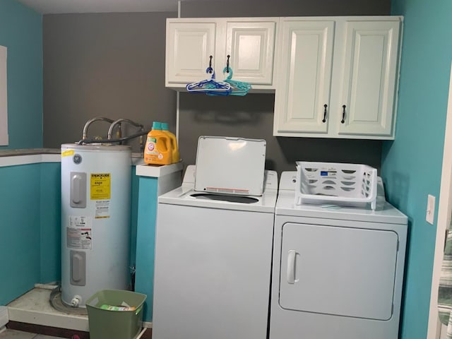 laundry room featuring cabinets, water heater, and washer and dryer