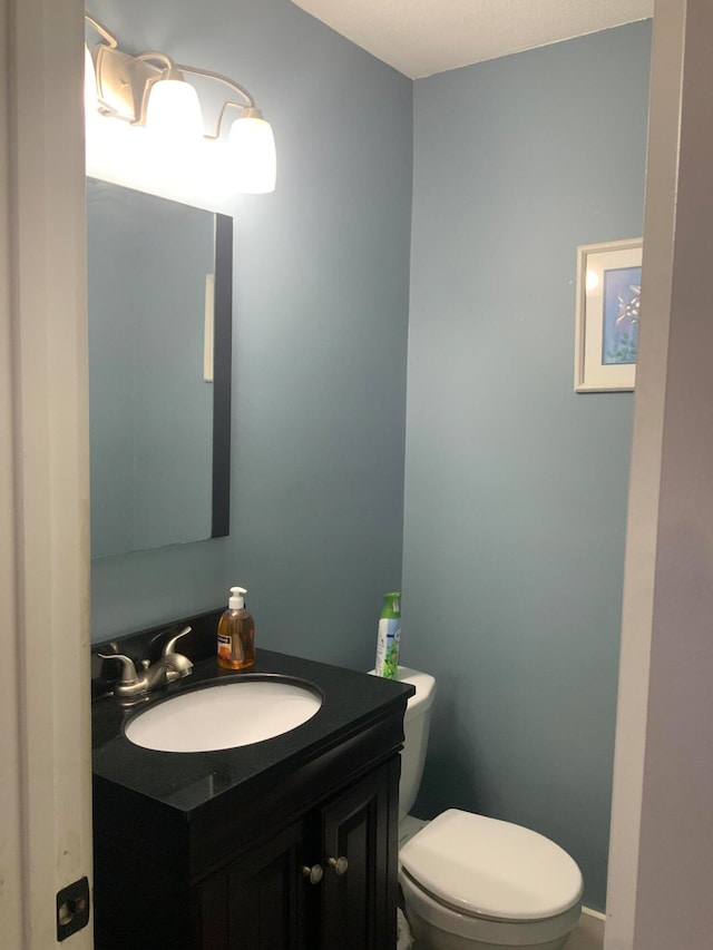 bathroom featuring toilet and vanity