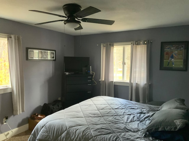 carpeted bedroom with ceiling fan