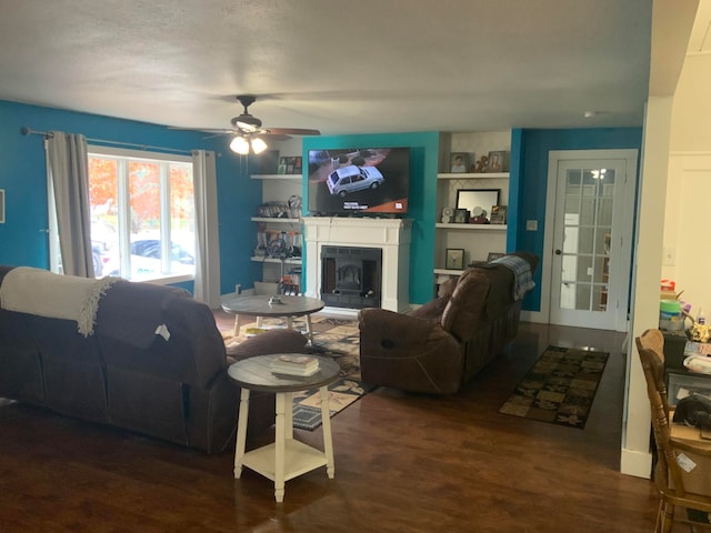 living room with dark wood-type flooring and ceiling fan