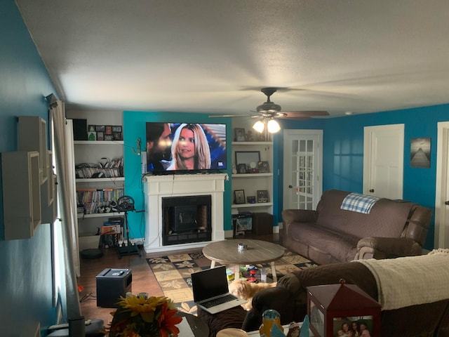 living room with hardwood / wood-style flooring and ceiling fan