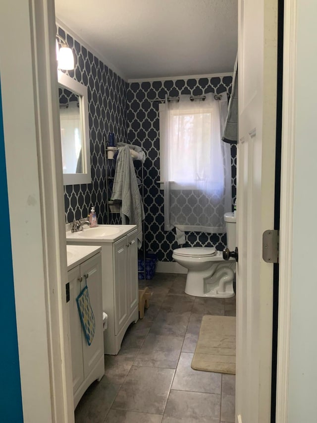 bathroom with vanity, toilet, and tile patterned floors