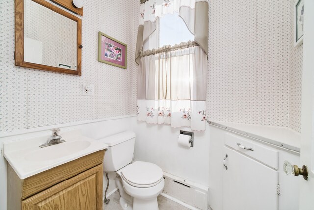 bathroom featuring toilet and vanity