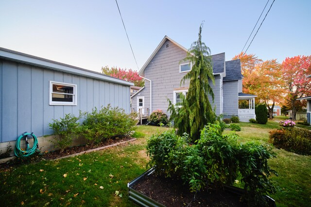 rear view of house featuring a lawn