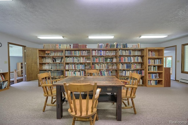 carpeted dining space with a textured ceiling