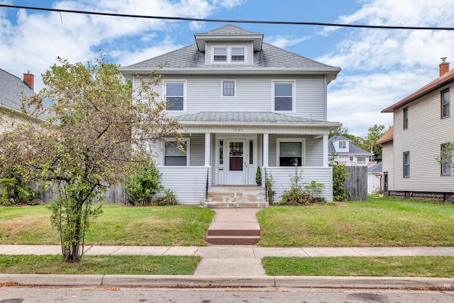 view of front of house featuring a front lawn and covered porch