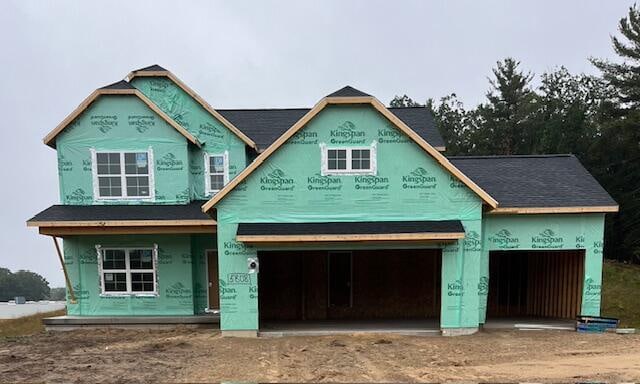 property under construction featuring a porch and a garage