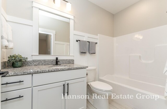 full bathroom featuring shower / washtub combination, vanity, and toilet