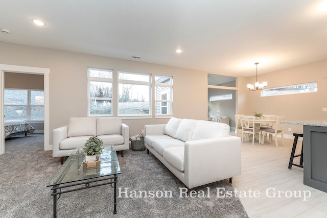 living room featuring a chandelier and plenty of natural light