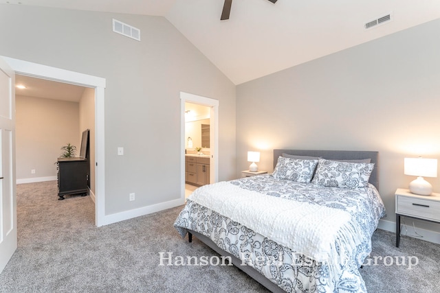 bedroom with ceiling fan, light colored carpet, connected bathroom, and high vaulted ceiling