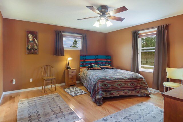 bedroom with ceiling fan and light wood-type flooring